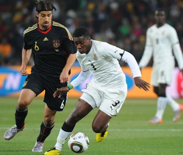 Germany's midfielder Sami Khedira (L) vies with Ghana's striker Asamoah Gyan.