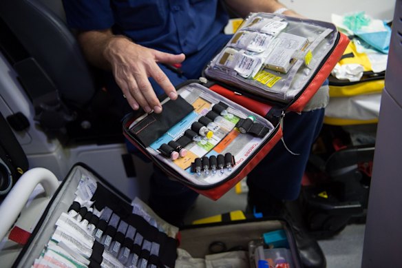 11:57pm. A NSW Ambulance Paramedic checks equipment and drug supplies during their shift.