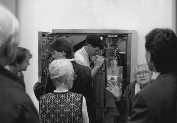 Members of the Combined Pensioners’ and Superannuants’ Association wait while CityRail officers investigate a malfunction in one of the new ticket machines. April 24, 1993.