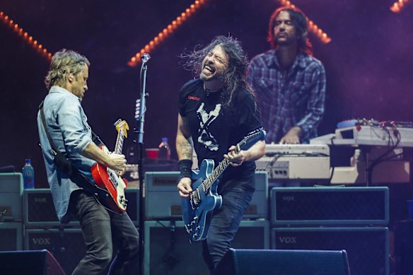 Dave Grohl (centre) of Foo Fighters performs onstage with guitarist Chris Shiflett (left) and keyboard player Rami Jaffee at GMHBA Stadium in Geelong during the US rock band's only Australian show.