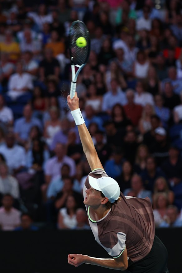 Jannik Sinner serves.