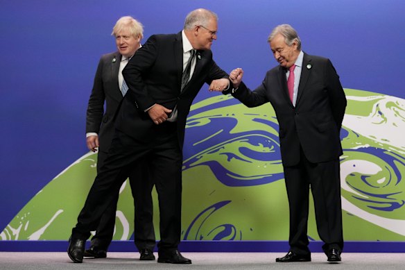British Prime Minister Boris Johnson (L) and UN Secretary-General Antonio Guterres (R) greet Australian Prime Minister Scott Morrison as they arrive for COP26 at SEC on November 1, 2021 in Glasgow.