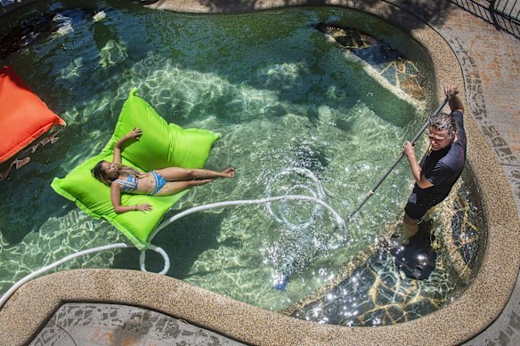 At Gabriel Thallon's Travellers Oasis Backpackers. Gabriel cleans the backpackers pool whilst a lone backpacker Rina Yamauchi relaxes in the sun. Gabriel now faces the reality of selling property to survive.
