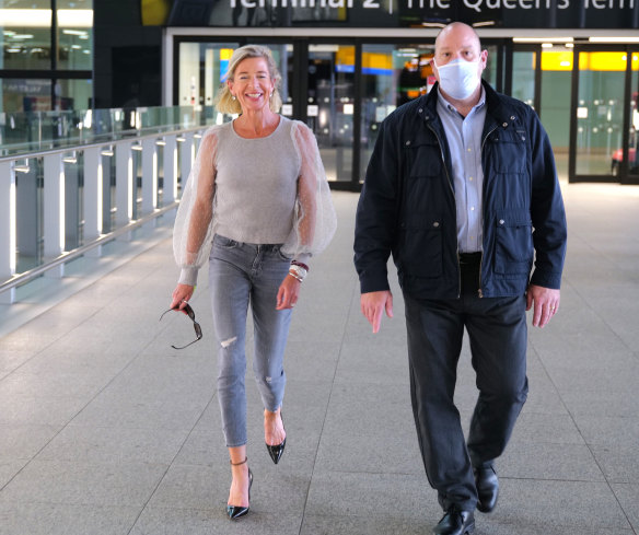 Far-right British commentator Katie Hopkins, left, at Heathrow Airport, being escorted to a Mercedes. 