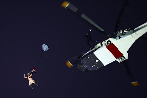 An actor dressed to resemble Queen Elizabeth parachutes into the stadium during the opening ceremony of the London 2012 Olympic Games.  Photo by AFP