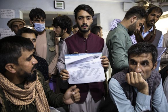 A man shows a certificate of appreciation from an American defense contractor while seeking help with his Special Immigrant Visa (SIV) application at Herat Kabul Internet cafe on August 8, 2021 in Kabul, Afghanistan. Many Afghans are in desperate need of assistance completing the forms and obtaining the required human resources letters, a particular challenge for those whose US government work ended years ago. The Biden administration expanded refugee eligibility for Afghans as the Taliban escalates violence in the war-torn country. Thousands of Afghans who worked for the United States government during its nearly 20-year war here now fear for their safety as the US withdraws its troops from the country.