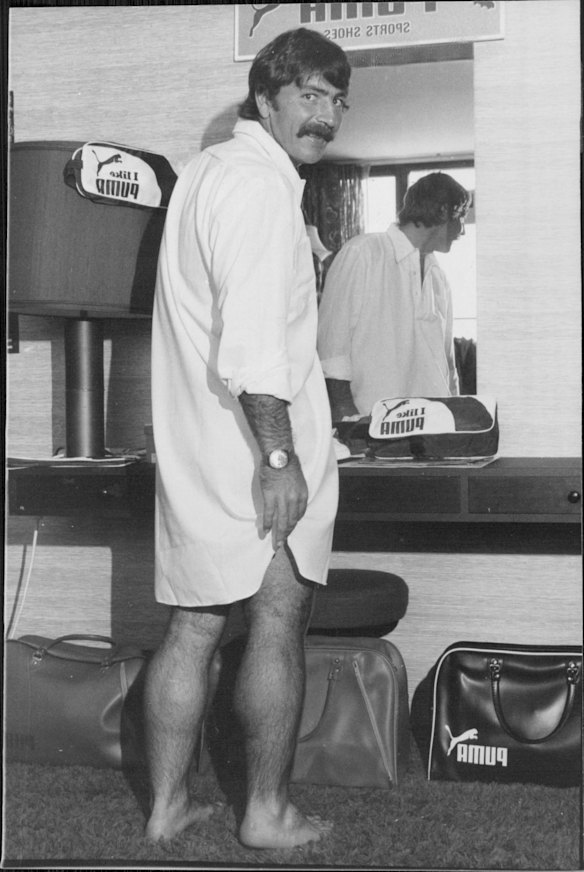 WA's Test wicketkeeper Rod Marsh decided a nightshirt was the answer to his day-wear problem. The rigors of wicketkeeping made it impossible for him to keep his shirt in. He squats hundreds of times during a match, stretches, dives and rolls and his shirt usually ends up flapping along behind him.
He decided to get together with a Melbourne sportswear manufacturer and they came up with this design called the "Ironman".
Marsh had three of the special shirts made.
He has found it difficult to keep tucking his shirt in with his bulky gloves and he is confident his problems will now be over. November, 1976.