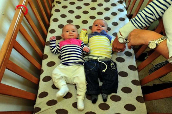 Canberra Capitals coach Carrie Graf, with partner Camille Chicheportische and baby twins Bentley (blue and yellow top) and Charli (blue and pink top).