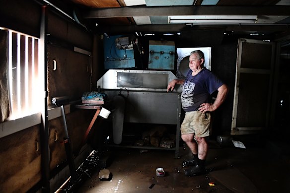 Furniture maker Geoff Hannah, creator of the famous Hannah Cabinet, which was destroyed in flood after the waters reached the Lismore Regional Art Gallery. He is pictured in his flood-affected workshop and home in downtown Lismore on Wednesday.