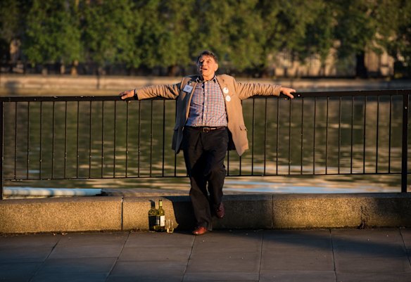 A vote LEAVE 'Counting Agent' drinks wine and soaks up the early morning sun outside Vote Leave HQ, Westminster Tower, London.