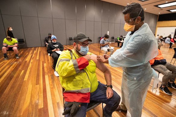 Not all tradies were protesting. This photograph, taken as some were marching in protest against vaccination, shows warehouse worker Daniel Matcham getting the jab at a vaccine clinic in Hoppers Crossing. 