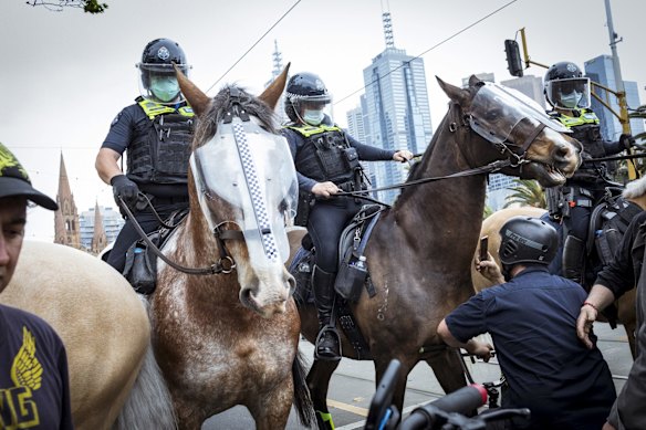 Mounted police clash with protesters outside the NGV.