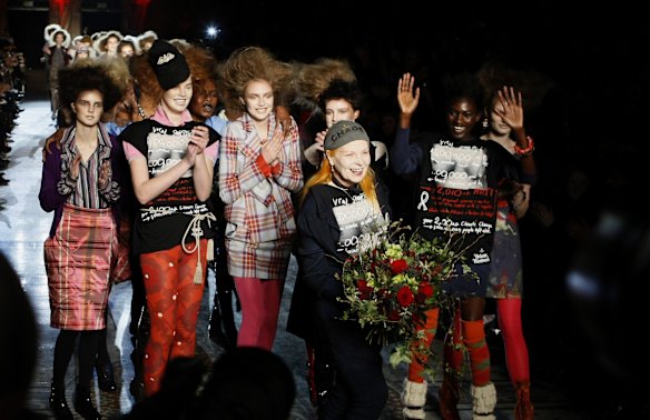 Vivienne Westwood, holds flowers as she takes the applause from the audience after her Red Label Autumn/Winter 2010 collection at London Fashion Week in London, Sunday, Feb. 21, 2010.