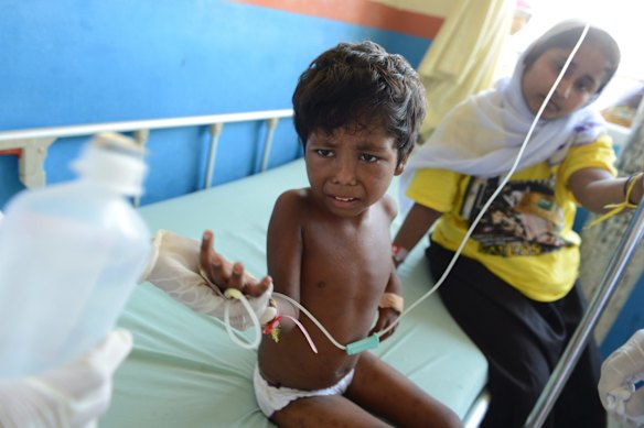 TOPSHOTS
A rescued Rohingya child from Myanmar is attended to by an Indonesian nurse at a hospital in Langsa in Aceh province on May 19, 2015. The migrants mostly Rohingyas from Myanmar and Bangladesh were rescued by Indonesian fishermen off Langsa on May 15. The Philippines said May 19 it was ready to help Rohingya and Bangladeshi boatpeople, as its Southeast Asian neighbours faced outrage for turning them away. 