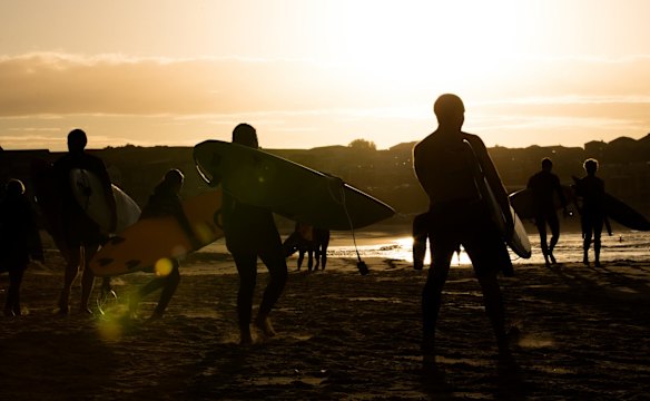 Surfers race to the water at Bondi.