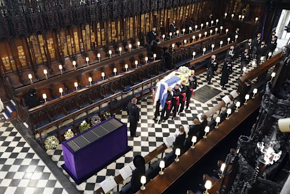 Britain's Queen Elizabeth watches as pallbearers carry the coffin of the Duke of Edinburgh during his funeral at St George's Chapel
