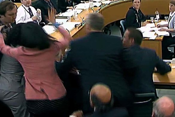 Wendi Deng, in pink, leaps to the defence of her husband. 