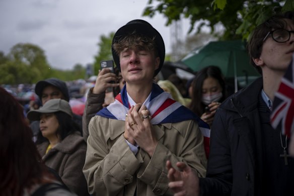 Royal fan Ben Weller watches King Charles's coronation on a screen in Hyde Park in London.