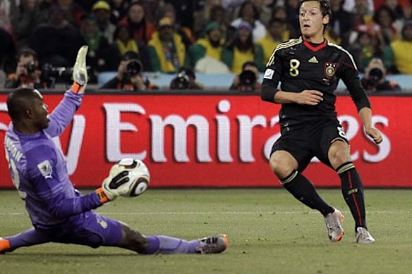 Ghana goalkeeper Richard Kingson, left, saves a shot by Mesut Oezil of Germany.
