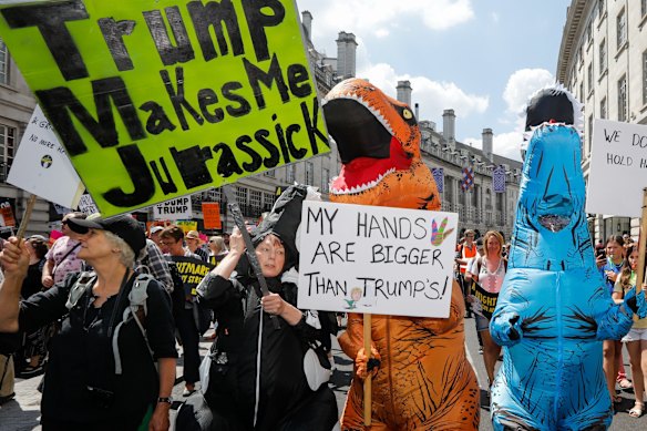 'Trump Makes Me Jurassick'.  Demonstrators dressed in dinosaur costumes protest against U.S. President Donald Trump in central London, U.K., on Friday, July 13, 2018. T