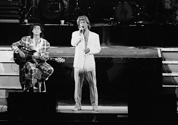 In this April 7, 1985 file photo, George Michael and Andrew Ridgeley of the British group WHAM! perform during a concert in Peking, China. 