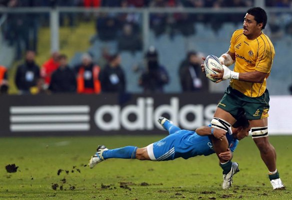 Australia's Sitaleki Timani  is tackled by Italy's Luciano Orquera.