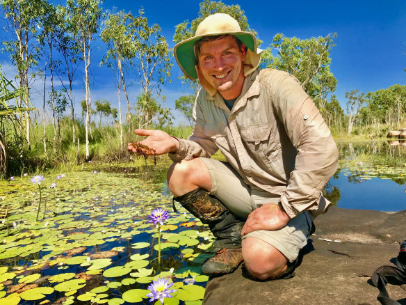 Curtin researcher Adam Cross holding a sample of the rare carnivorous plant at the site of the discovery. 
