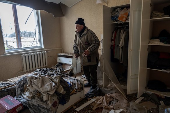 Vitale Fedotov, 70, looks through his war-damaged home in Makarov. Fedotov said he was lying in bed when his home was struck by a bomb on March 7 during the Russian attack on the town.