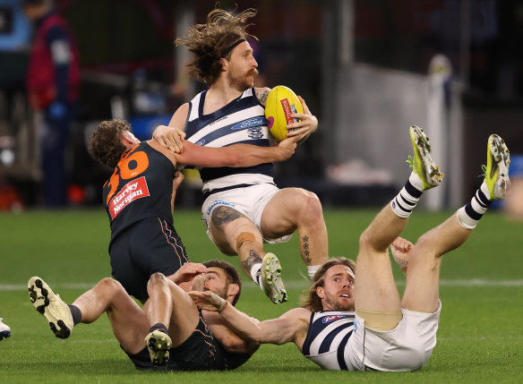 Geelong’s Zach Tuohy is tackled by Harry Perryman.