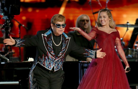 Elton John and Miley Cyrus after performing <i>Tiny Dancer</i> at the 60th annual Grammy Awards.