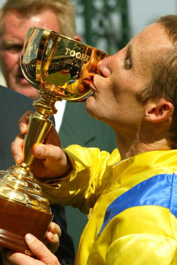 Damien Oliver kisses the 2002 Melbourne Cup.