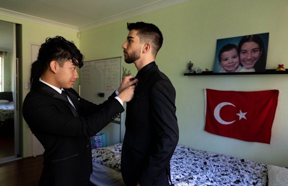 Sydney Boys High School students, Sean Montalbo and Ozan Akarsu, get ready for their school formal at Ozan's house in Rydalmere, Sydney. On the wall is a photo of Ozan with his older sister, who lives overseas, and who he misses. 
