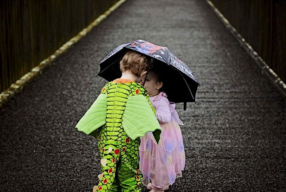 My two little treasures taking shelter from the rain during a ?dress up? and feed the ducks walk around the lake at Gungahlin.
