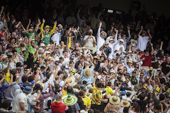 The MCG crowd celebrate a wicket on day one.