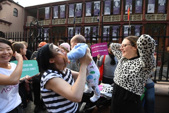 Supporters of creating a safe access zone around abortion clinics in NSW gather outside NSW Parliament House in Sydney, Thursday, June 7, 2018. 