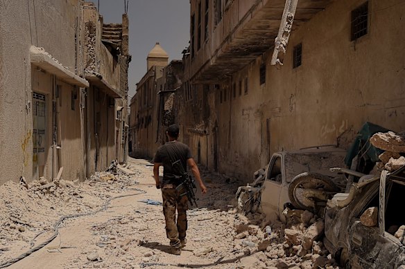 An Iraqi Special Forces soldier walks through the devestated streets of West Mosul.