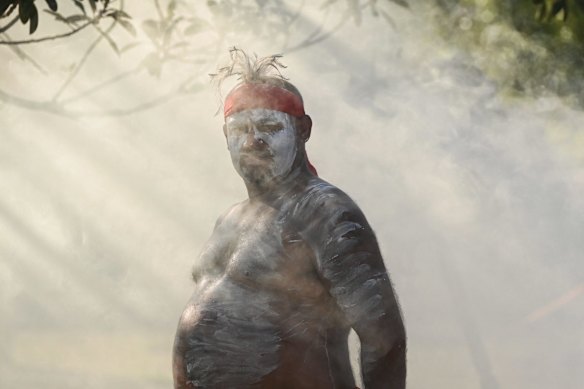 An Indigenous man performs during a smoking ceremony by members of Koomurri at the Wugulora morning ceremony at Barangaroo on Australia Day.