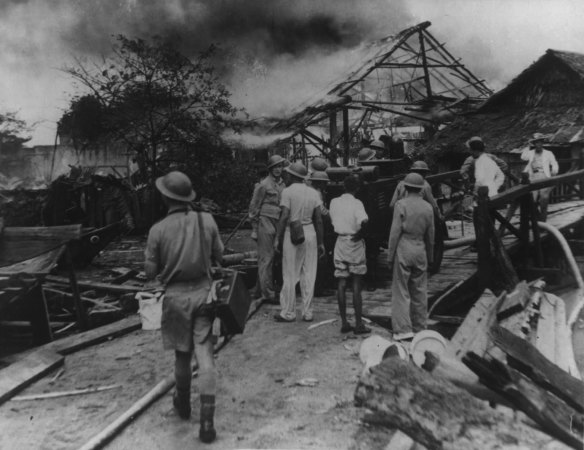 “Chinese of the passive defence services do great work after Jap bombs fall on a village in Singapore area.” February 1942. 