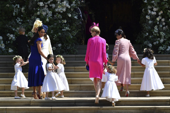 Kate, Duchess of Cambridge, third left, and Meghan Markle's friend, Canadian fashion stylist Jessica Mulroney, second left, holds bridesmaids hands as they arrive for the wedding ceremony at Windsor Castle in 2018.