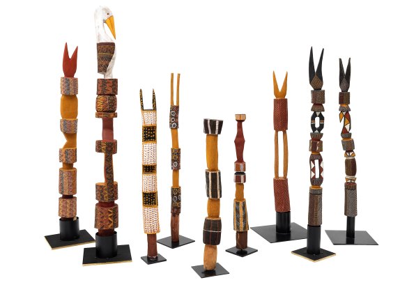 Pius Tipunguti, Timothy Cook, Kenny Brown, Patrick Freddy Puruntatameri, Pedro Wonaeamirri, Raelene Kerinauia Lampuwatu, Leon Puruntatameri, Pukumani tutini 2002–09 (installation view), 
earth pigments on Ironwood (Erythrophleum chlorostachys). 
NGV. 