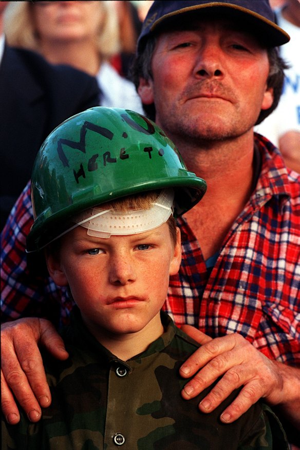 Terry Campion and his son Rhys Campion (10) from Tooborac at the Patrick v Wharfies dispute at Web Dock in 1998. His hard hat reads "MUA Here to stay". Photo: Simon O'Dwyer