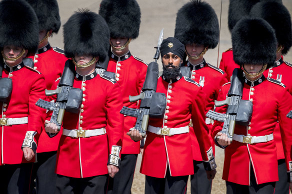 Charanpreet Singh Lall, one of the Coldstream Guards marches, wearing a turban. 