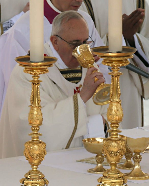 Pope Francis drinks from a chalice as he celebrates his installation Mass.