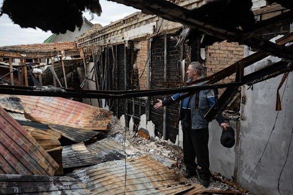 Mykola, 70, assesses the damage to his burnt house in Ozera. The towns around Kyiv are on a long road to what they hope is recovery, following weeks of brutal war as Russia made its failed bid to take Ukraine's capital.
