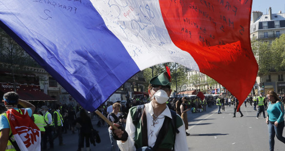 A man waves the French flag during the demonstration. 