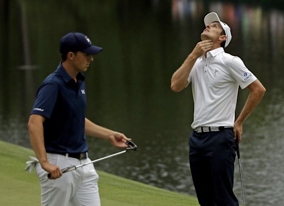 Justin Rose reacts after missing a putt on the 16th as Jordan Spieth prepares.