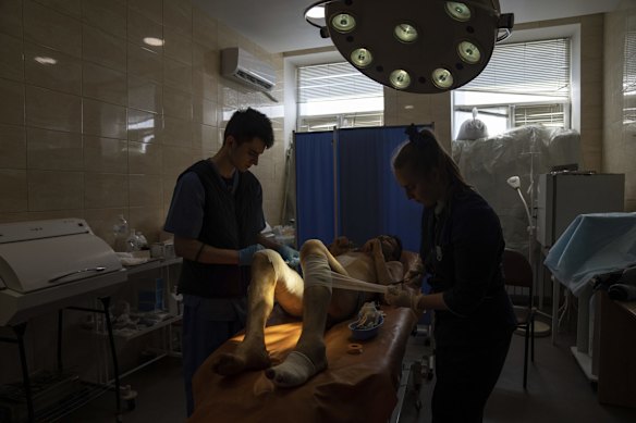 Medical workers treat Volodymyr Nikiforov, 40, injured by shelling near Barvenkove at a hospital in Kramatorsk.