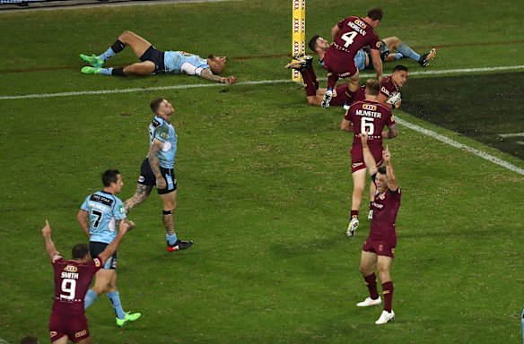 Cooper Cronk of the Maroons celebrates after Valentine Homes of the Maroons scored a try.