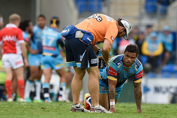 Josh Hoffman of the Titans receives attention on the field.