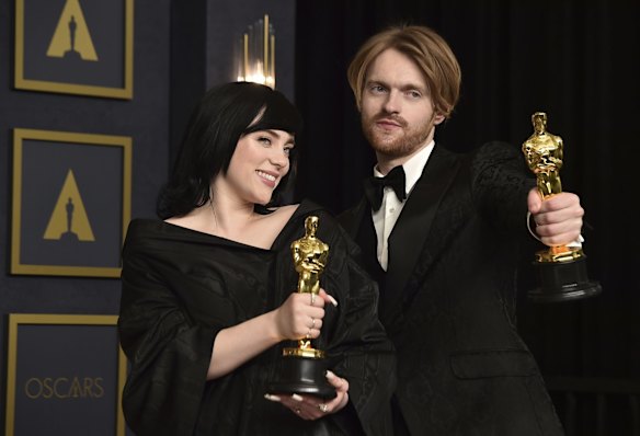Billie Eilish, left, and Finneas, winners of the award for best original song for "No Tie To Die" from "No Time To Die", pose in the press room.